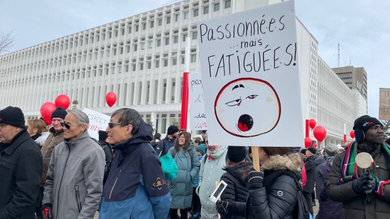 Group of strikers with signs.