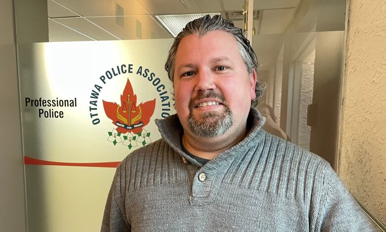 Ottawa Police Association president Matthew Cox stands in front of his office.