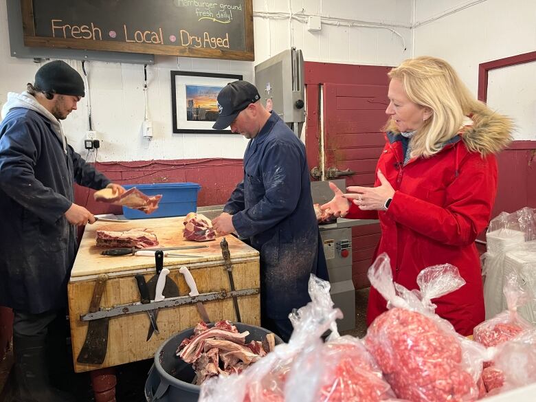 Liberal Leader Sharon Cameron at a meat shop speaking with voters.