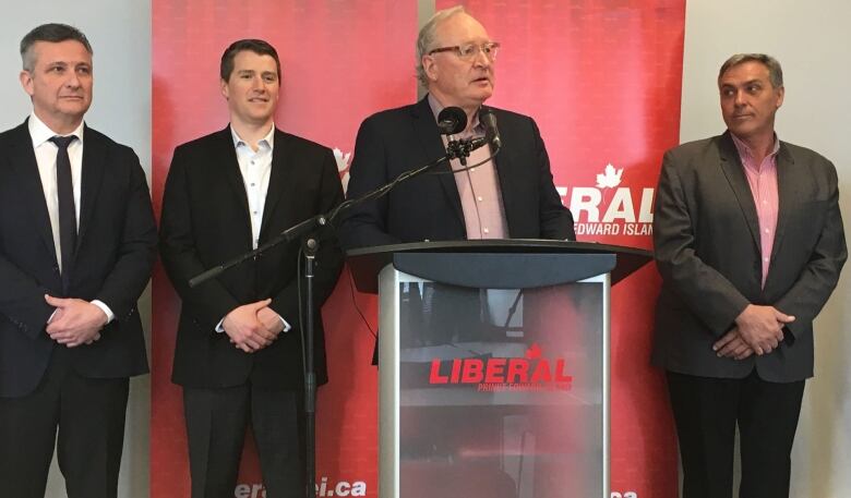 Former Liberal Leader and premier Wade MacLauchlan at a podium surrounded by other Liberal candidates.