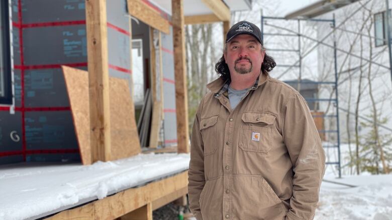 Andrew Nelson pictured outside house under construction