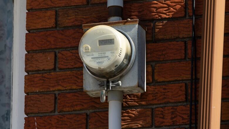 Electricity meter on the exterior wall of a house. 