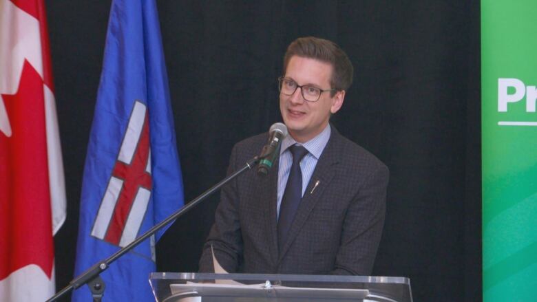 A man stands at a podium