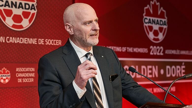 Canada Soccer executive member addresses reporters.