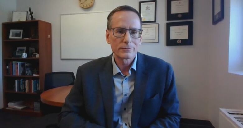 Greg Naterer, vice president of academic and research for UPEI, dressed in a dark blue blazer faces the camera during a Zoom interview.