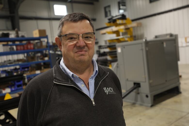 Tim Beals, head of business development with IJACK Technologies, stands in front of his company's vapour recovery unit in a warehouse in Moosomin.