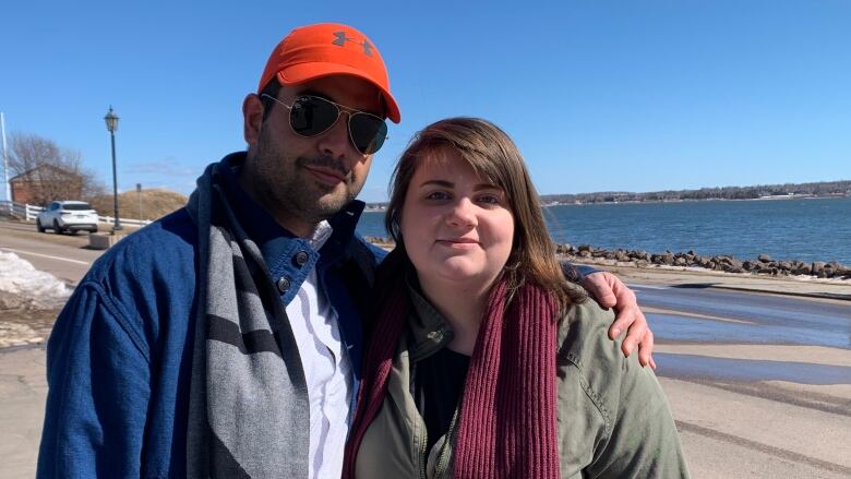 A couple stands in front of the Victoria Park boardwalk in Charlottetown