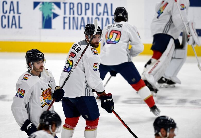 Hockey players take the ice. 