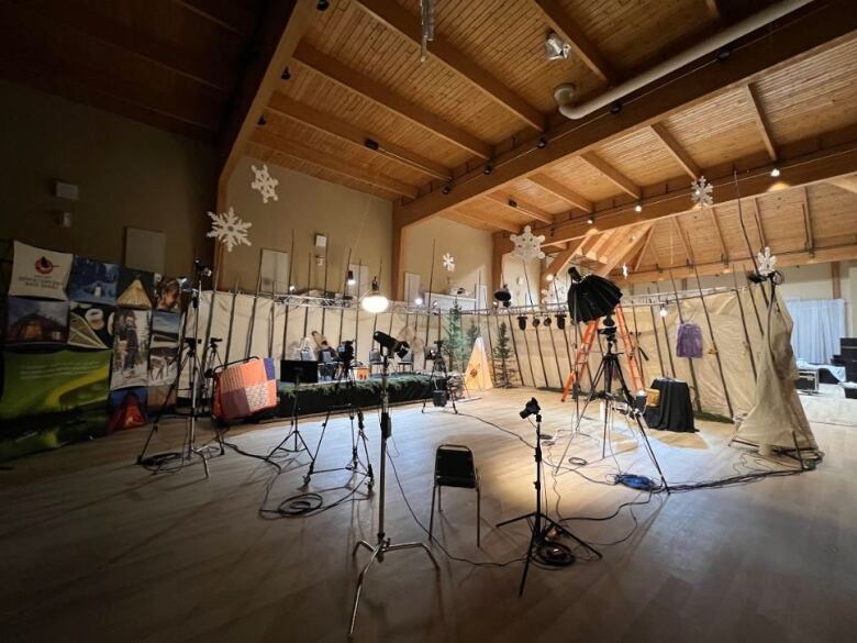 An empty television set with elements of Cree culture, such as a teepee and a canoe.