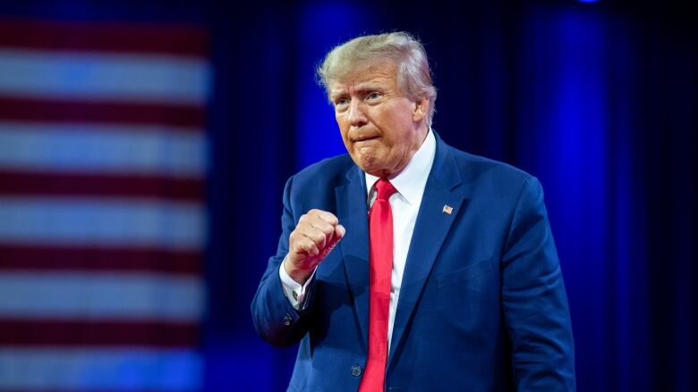 Former President Donald Trump pumps his fist after speaking at the Conservative Political Action Conference, March 4, 2023, Oxon Hill, Md. The Manhattan district attorney's office appears to be getting close to a decision on whether to charge Donald Trump over hush-money payments to Stormy Daniels during his 2016 presidential campaign. 