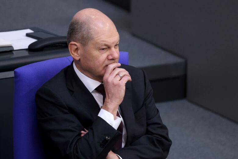 Olaf Scholz, Germany's chancellor is shown sitting in Germany's parliament building