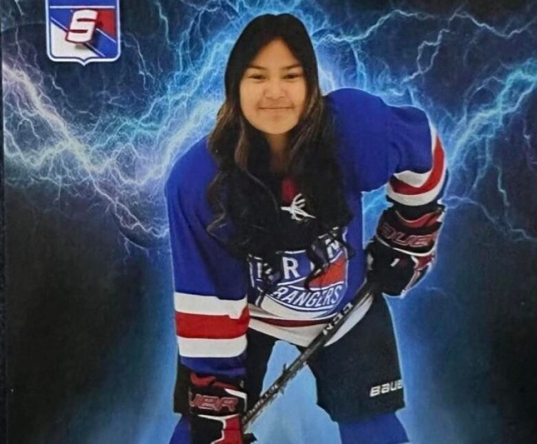 Girl poses for photo in hockey equipment