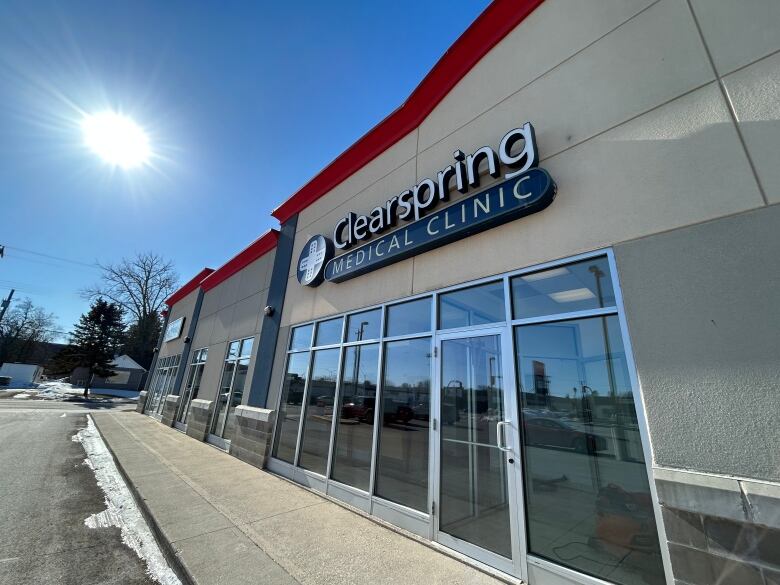 The exterior of a building in a strip mall with a sign reading 