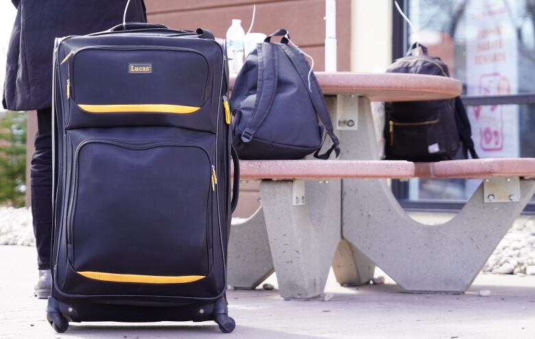 Luggage sits outside the Mountain Mart bus stop and gas station in the town of Plattsburgh, NY.