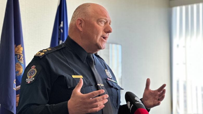 Chief Evan Bray is seen from his side profile speaking to reporters about his retirement. 