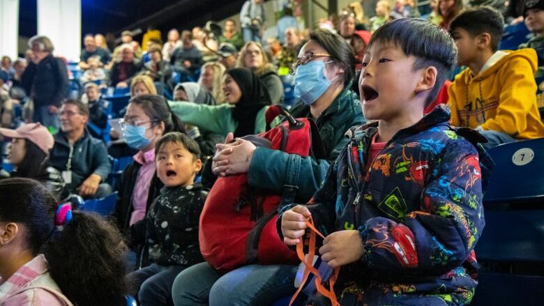 Children cheer during the performance of an entertainer.