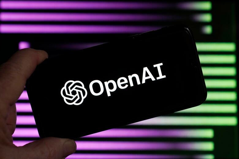 A device showing the words 'Open AI' in front of a screen showing purple and green lines.