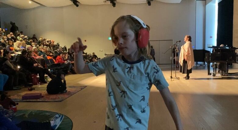 A child begins dancing with his noise cancellation headphones on at the sensor-accessible concert on April 2 at the Halifax Public Library. 