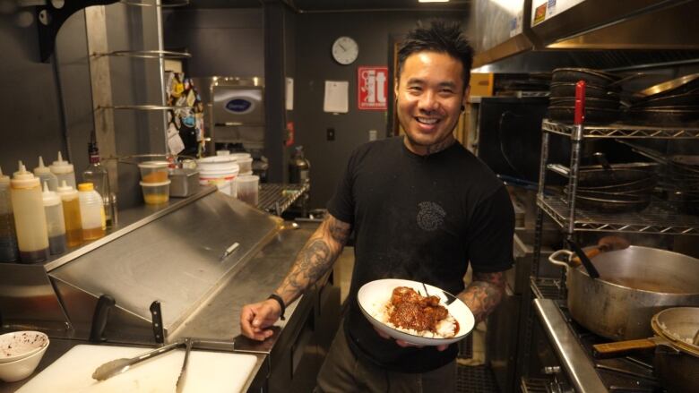 Chef JP Vives shows off his special Adobo Chicken recipe at his restaurant, Free Bird, in Lumsden, Sask.