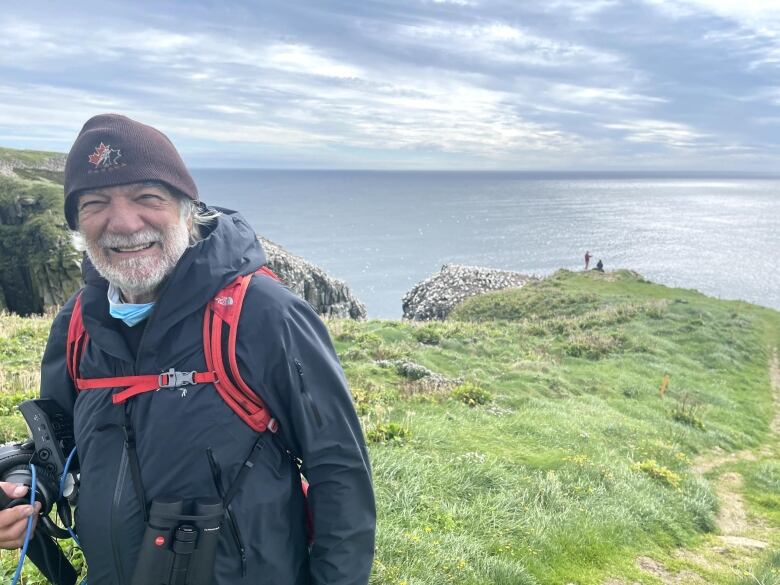  Bill Montevecchi in Cape St. Mary's, NFLD ... the ocean behind him.