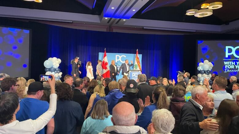 PC Leader Dennis King crosses a stage to meet his supporters on election night.