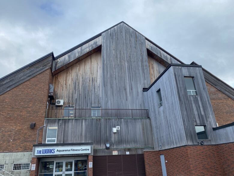 A triangular shaped building with a peak in the middle.