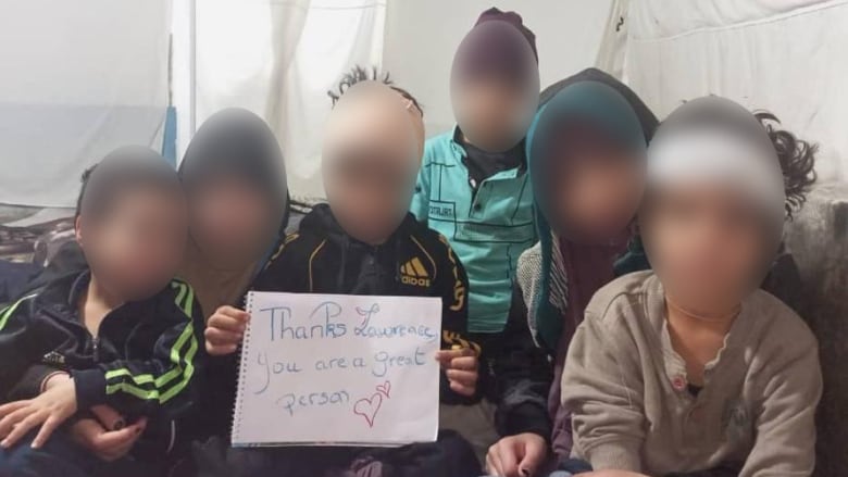 six children holding a sign 