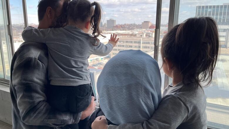 Family looks out window