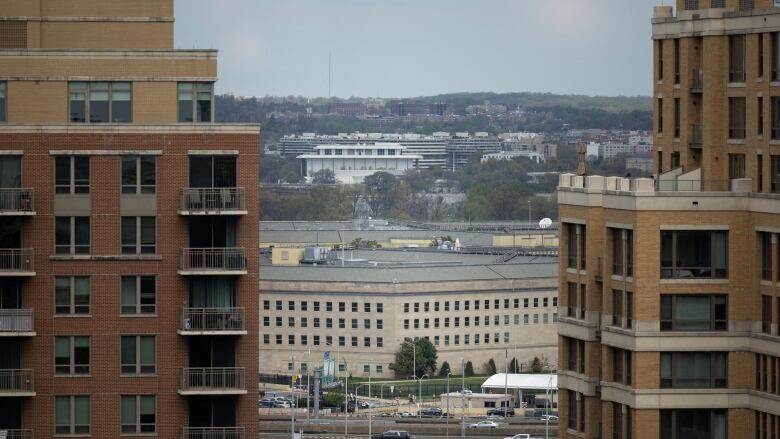 The U.S. Pentagon building is seen framed in the distance between the gap of two closer building.