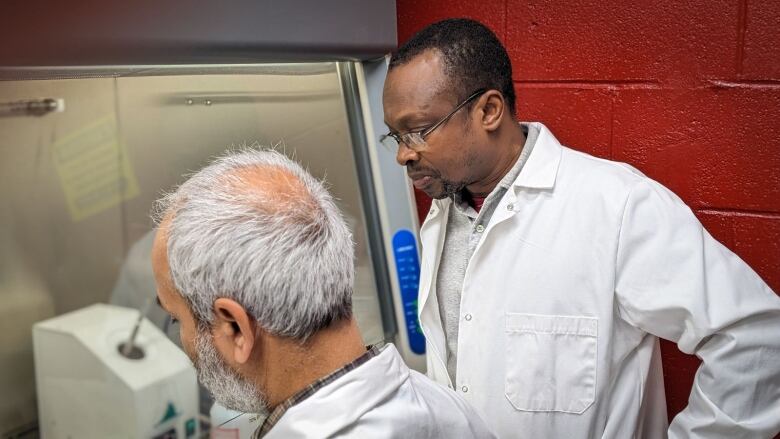 Two men looking at something in a lab