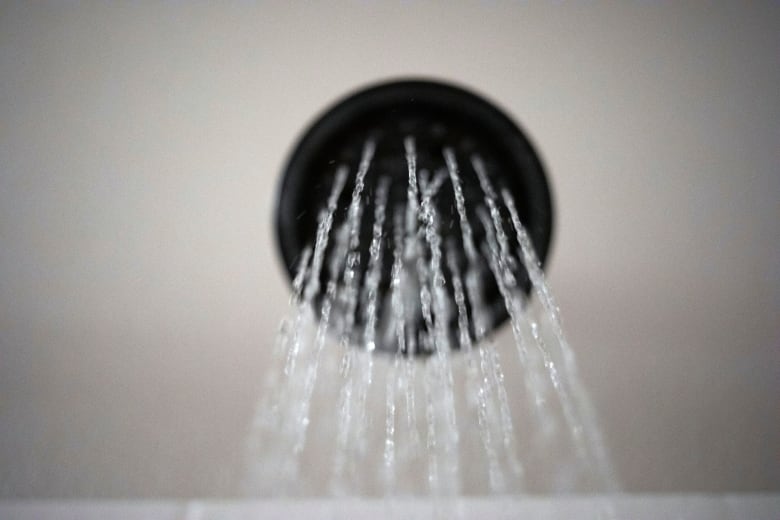 Water runs out of a shower head.