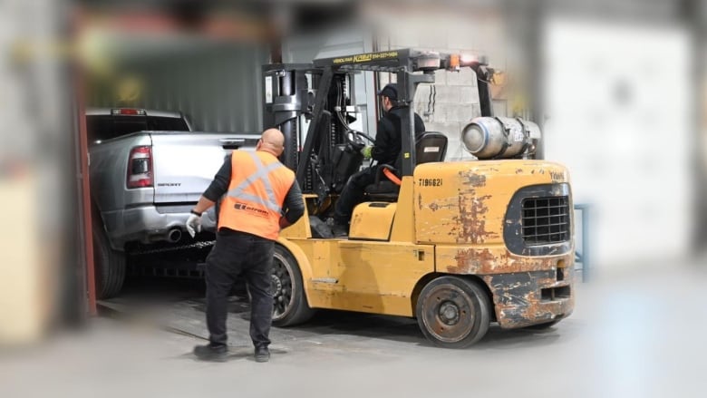 pickup truck being towed out of a container