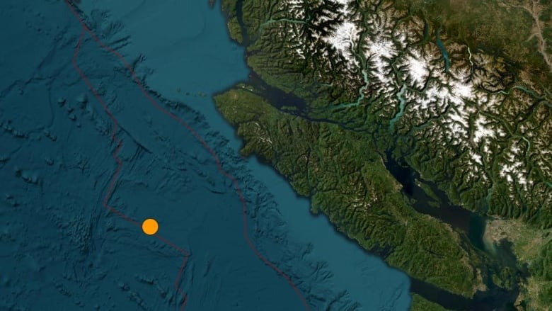 A satellite image of B.C.'s coast with an orange dot in the ocean indicating the epicenter of an earthquake. 