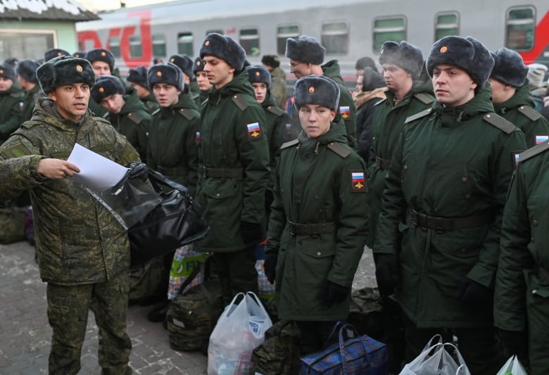 Russian conscripts called up for military service line up before boarding a train as they the depart for garrisons at a railway station in Omsk, Russia November 27, 2022. REUTERS/Alexey Malgavko