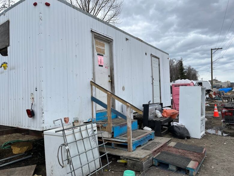 A small trailer on cinder blocks at an encampment in Prince George, B.C.