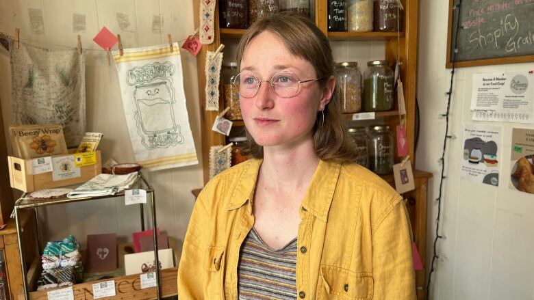 A volunteer, Hannah Estabrook, is shown at a food co-op in Halifax.