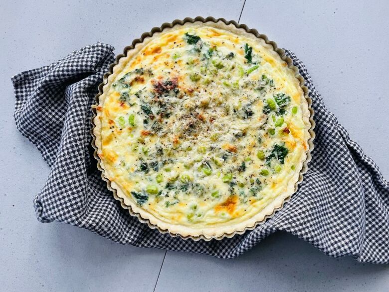 A quiche sits on a counter.