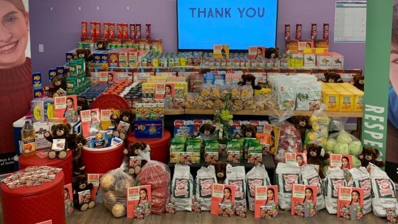 Food on table with thank you note above, was collected for project backpack in Summerside. 