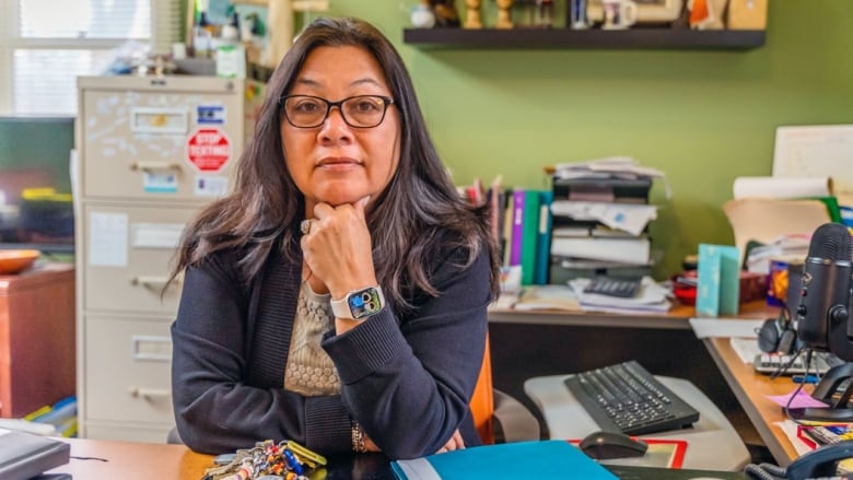 A support centre's executive director at an office desk.