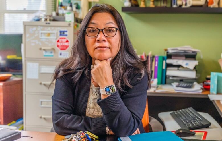 A support centre's executive director at an office desk.