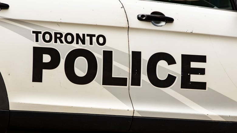 Detail view of 'Toronto Police' logo on the side of the vehicle.