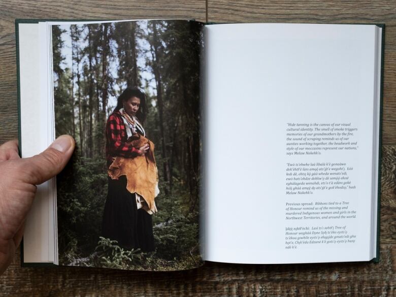 Book opened to page featuring Indigenous woman with moosehide.