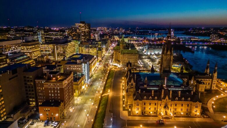 Legislature and office buildings in a city at night.