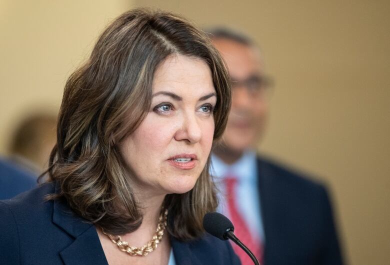 A woman speaks at a podium.