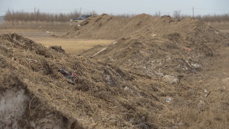 Garbage is seen on piles of dirty, melting snow at Regina's snow storage facility.