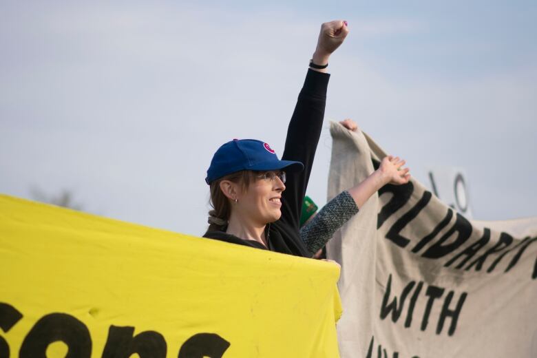 A person raises their fist in the air.