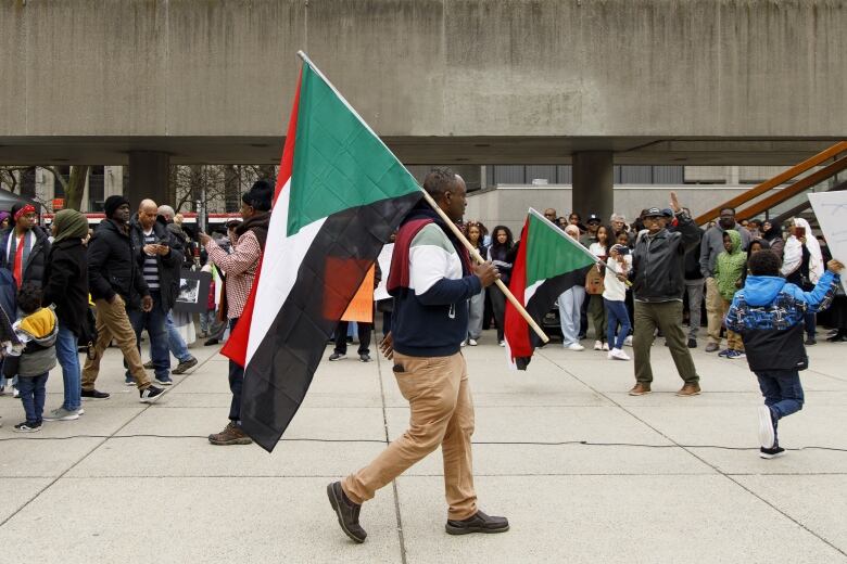 Supporters and members of Torontos Sudanese community hold a rally to oppose fighting in Sudan at Nathan Phillips Square in Toronto on April 23, 2023.