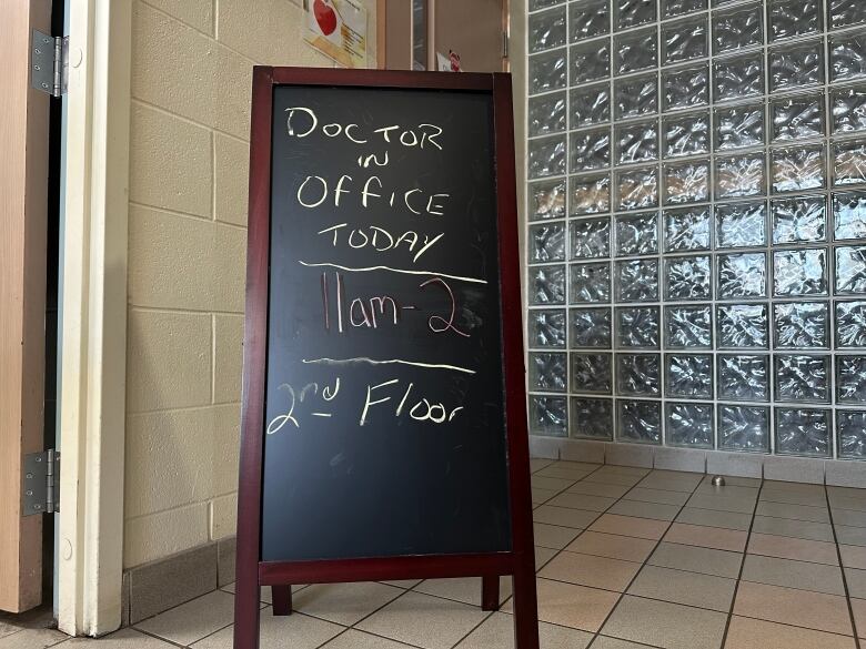 A sign reads 'Doctor in Office Today. 11 a.m. to 2 p.m. Second Floor.' 