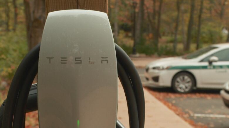 A Tesla charging station in the foreground