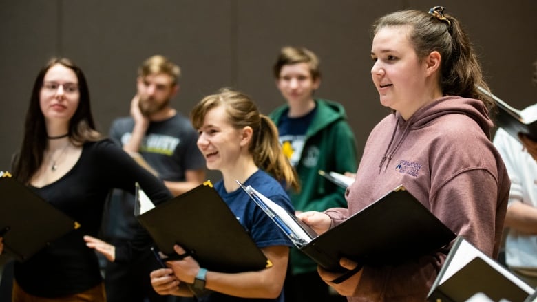 A choir of university students rehearses.